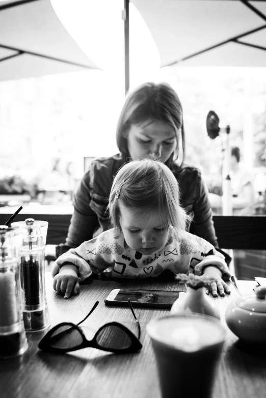 a woman working on her child's laptop while looking at the screen