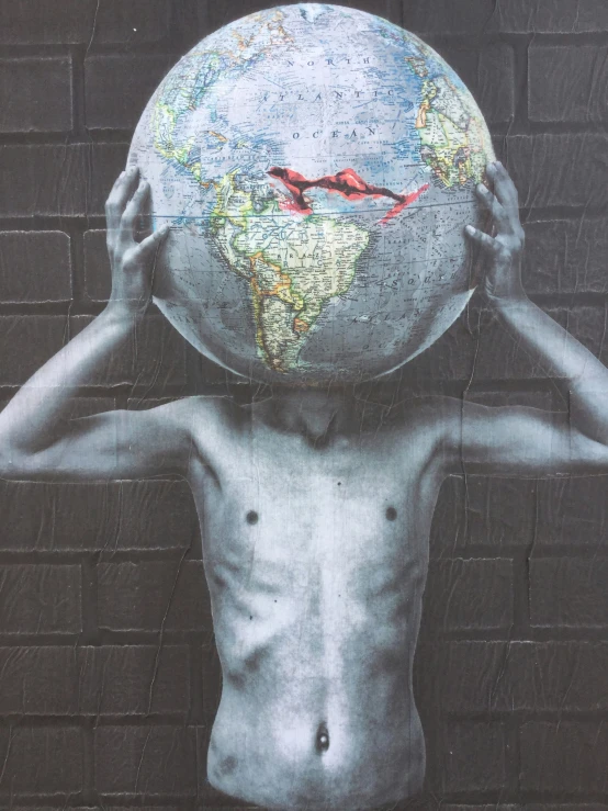 the boy is holding the world in his hands