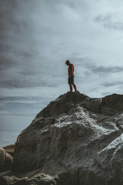 a man in a backpack standing on a large mountain