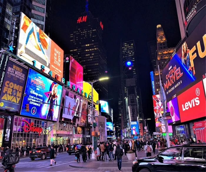 large billboards lit up the city's buildings and streets at night