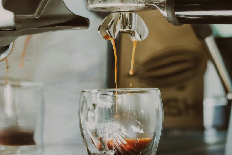 espresso is poured into a cup filled with liquid