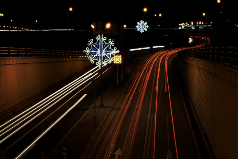 a car passes through the tunnel decorated with christmas lights