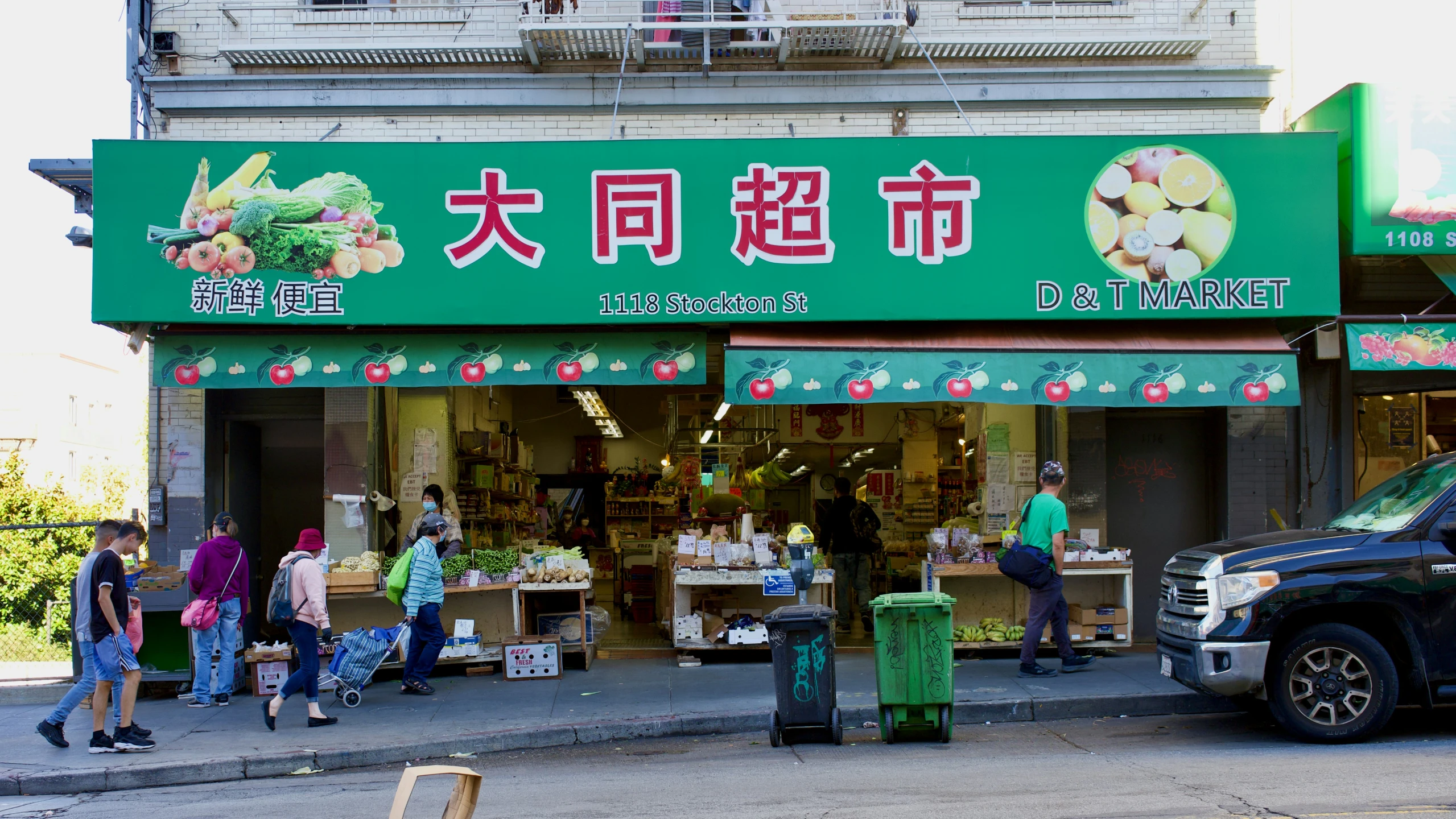 people standing on the street outside of a store