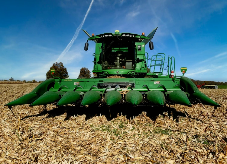 a tractor is in a field and has been cropped