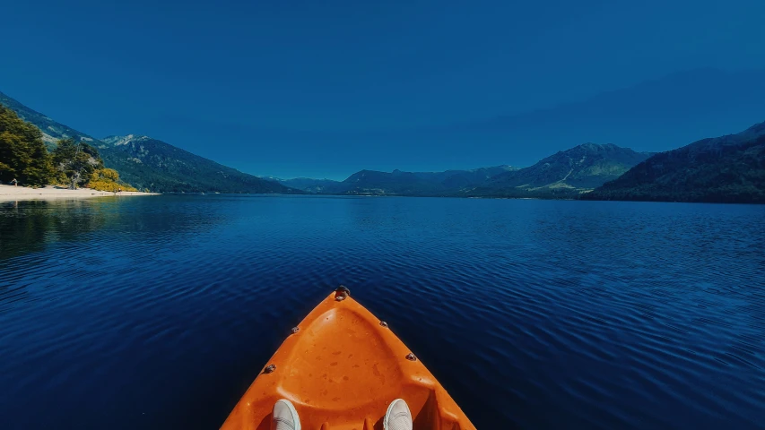 a boat is in the middle of a calm lake