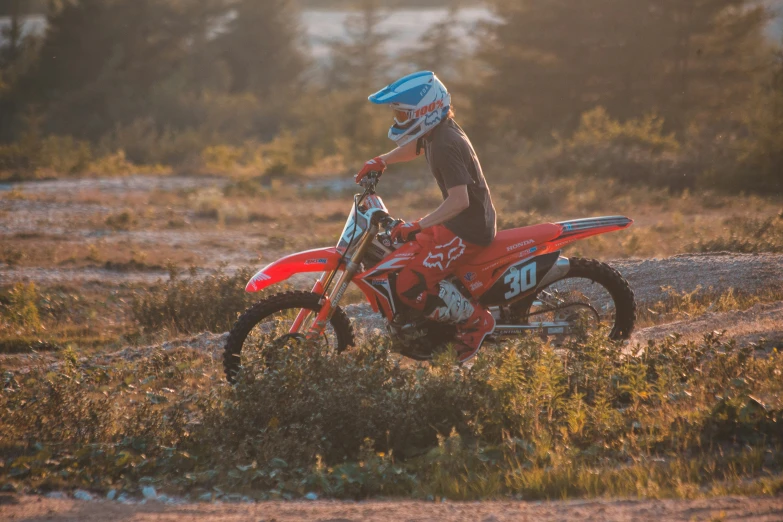 a person is riding a motorcycle in a field