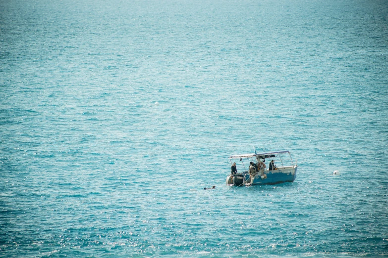 several people in a boat floating on a body of water