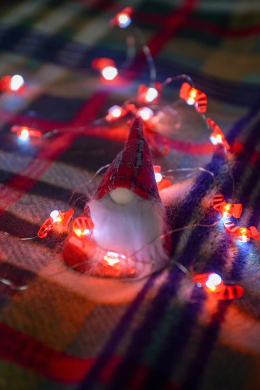 a little christmas hat is lit up on the table