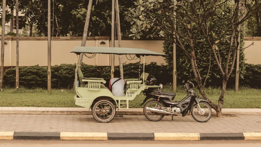 a motorcycle is parked next to a three wheeled carriage