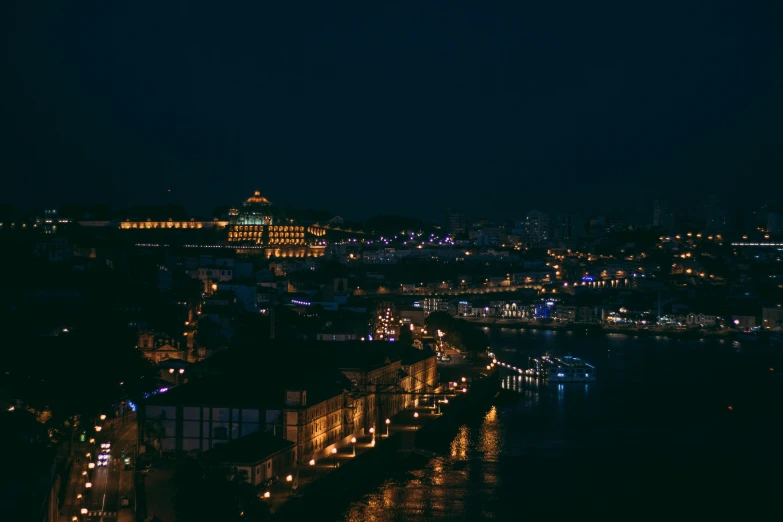 a city sits near the water at night