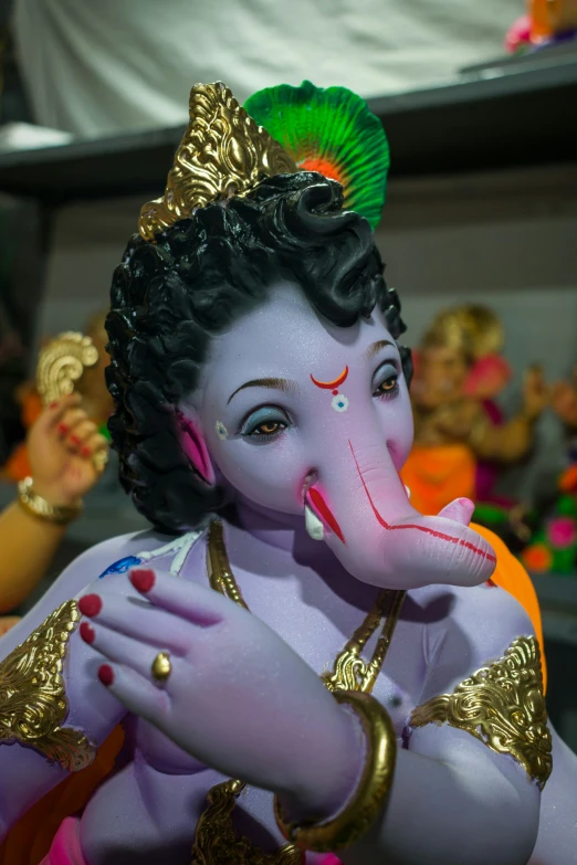 close up of the head and face of a statue of a person dressed as a god