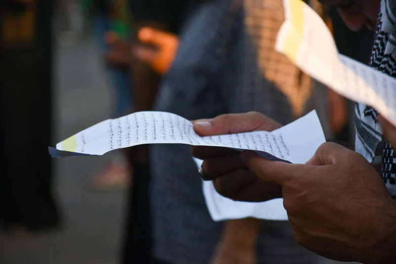 a man is holding an empty piece of paper