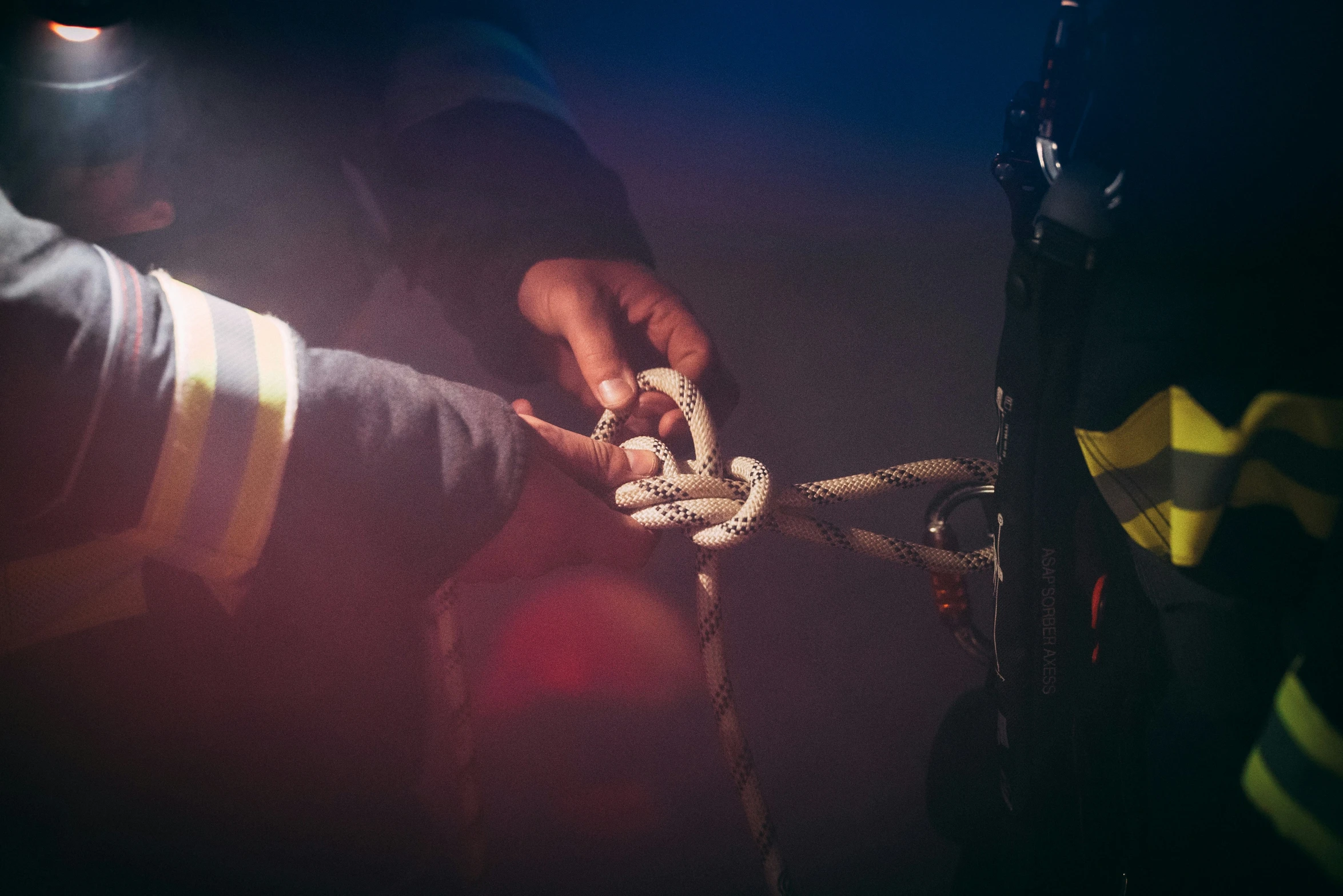 a fireman putting rope on a fire hydrant