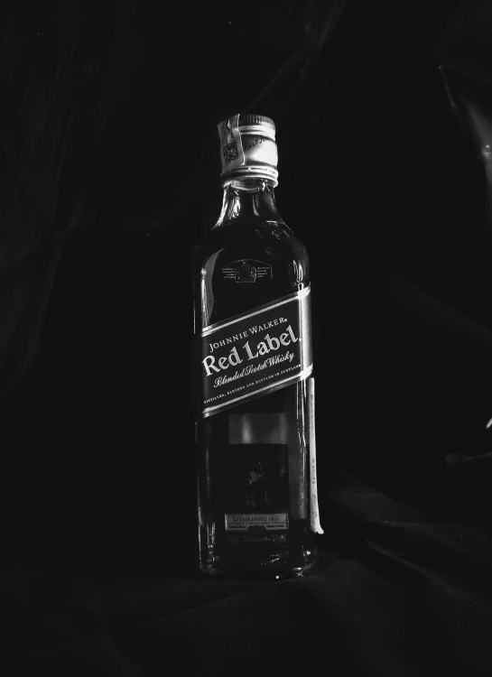 black and white po of bottle of whiskey