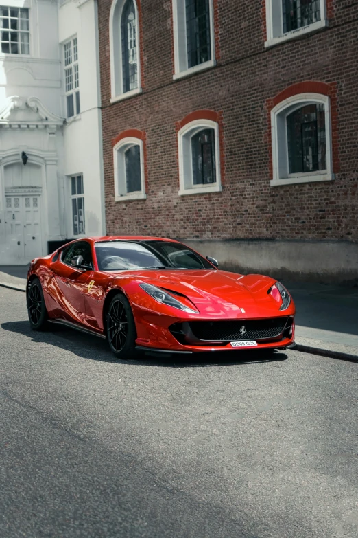 a red car parked in front of a tall brick building