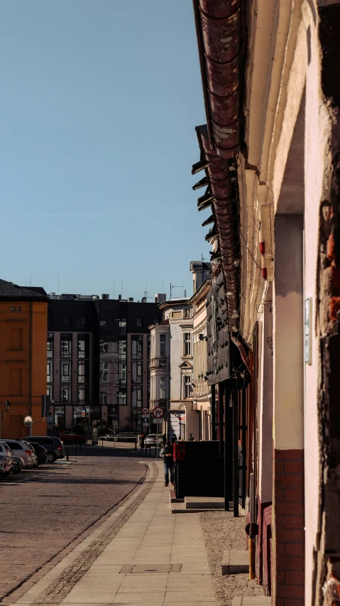 a empty city street in the middle of some buildings