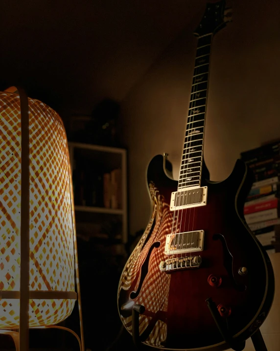 a guitar is being held up against a chair