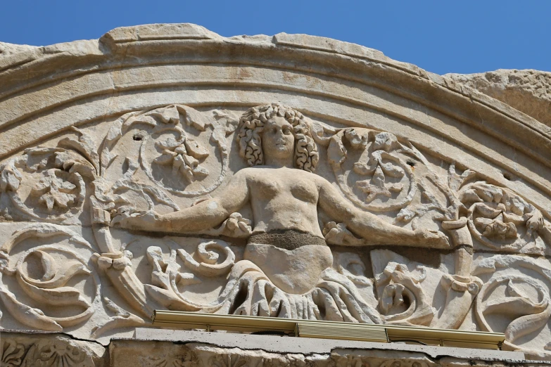 a statue is shown next to the intricate stone work