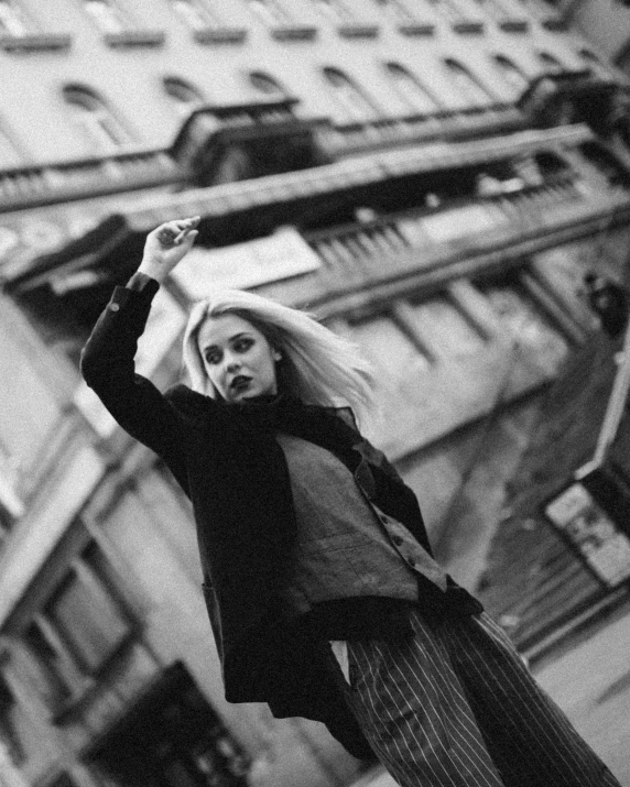 a woman is standing in front of a building