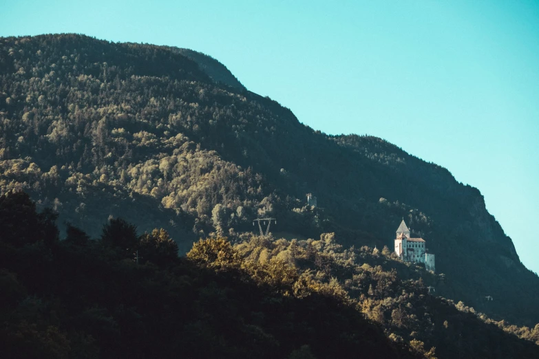 the mountain and tree line of an area with a church on it