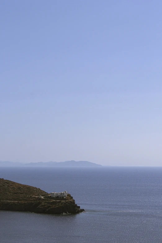 a boat on the water going past a lighthouse