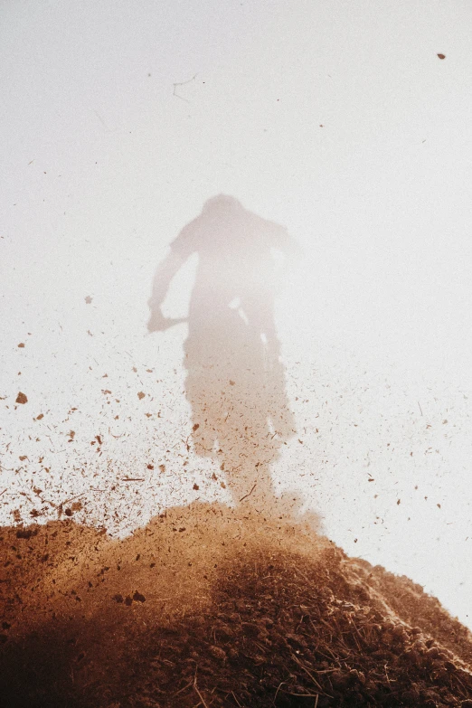 a person riding a bike down a dirt hill