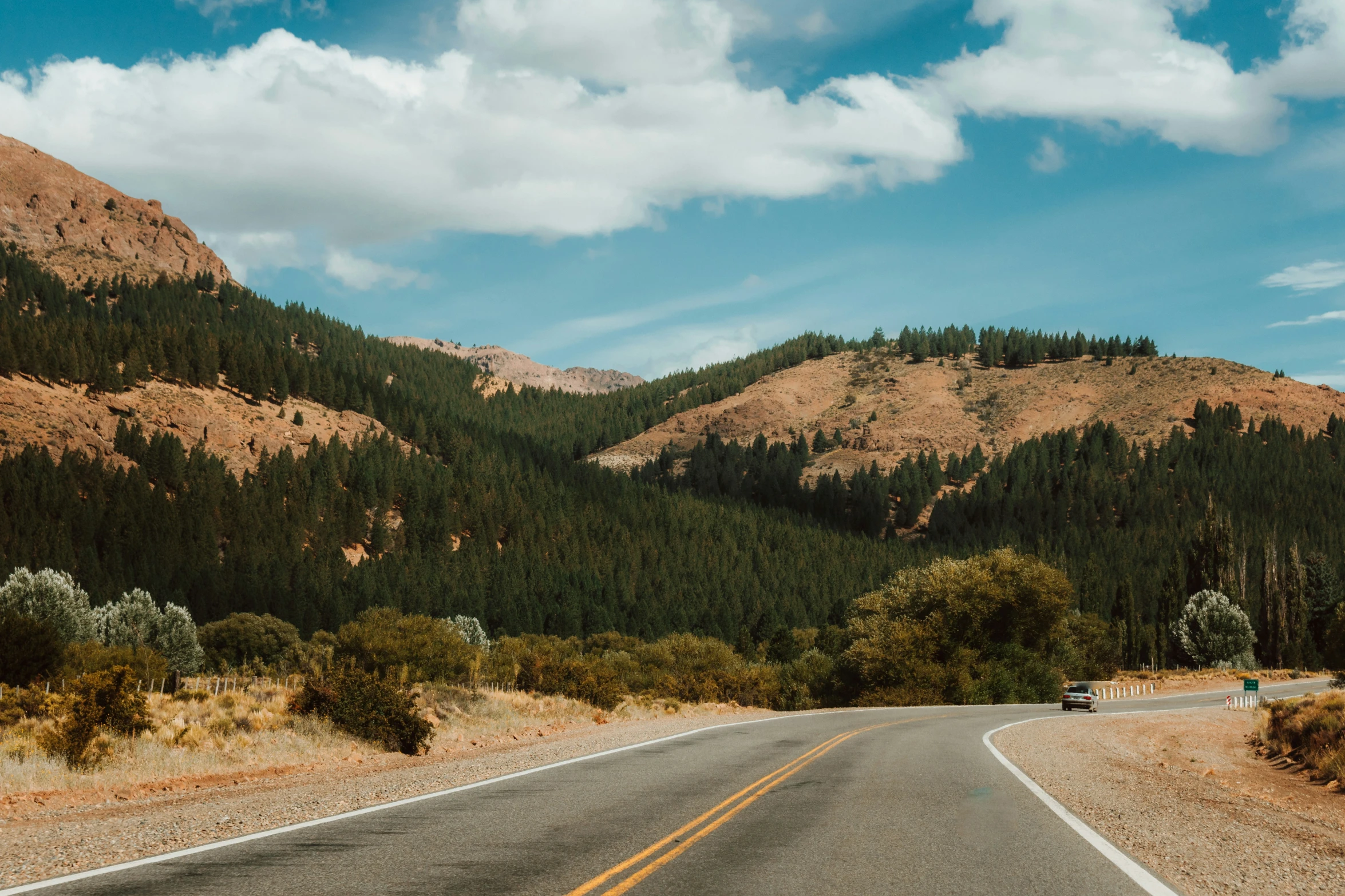 view of the roadway near the mountains in the daytime