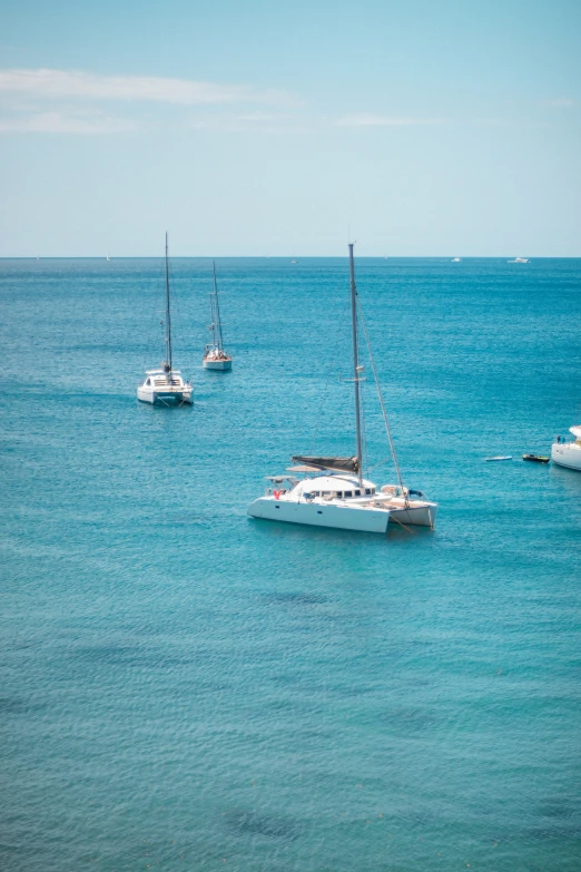 three small boats in a body of water