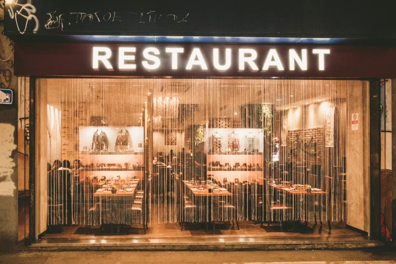 people are seated in the window of a restaurant