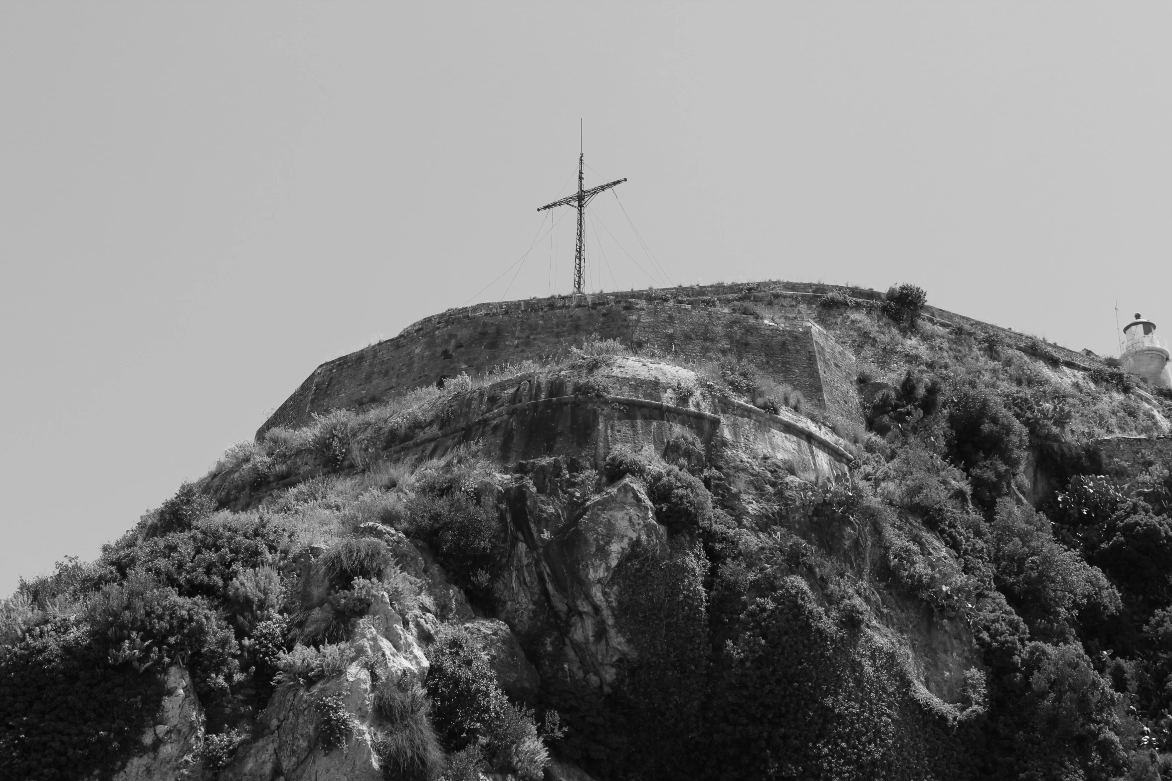 a cross on top of a tall mountain