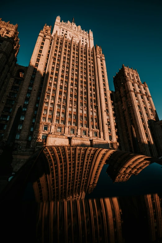 a building is reflected in the water near some buildings