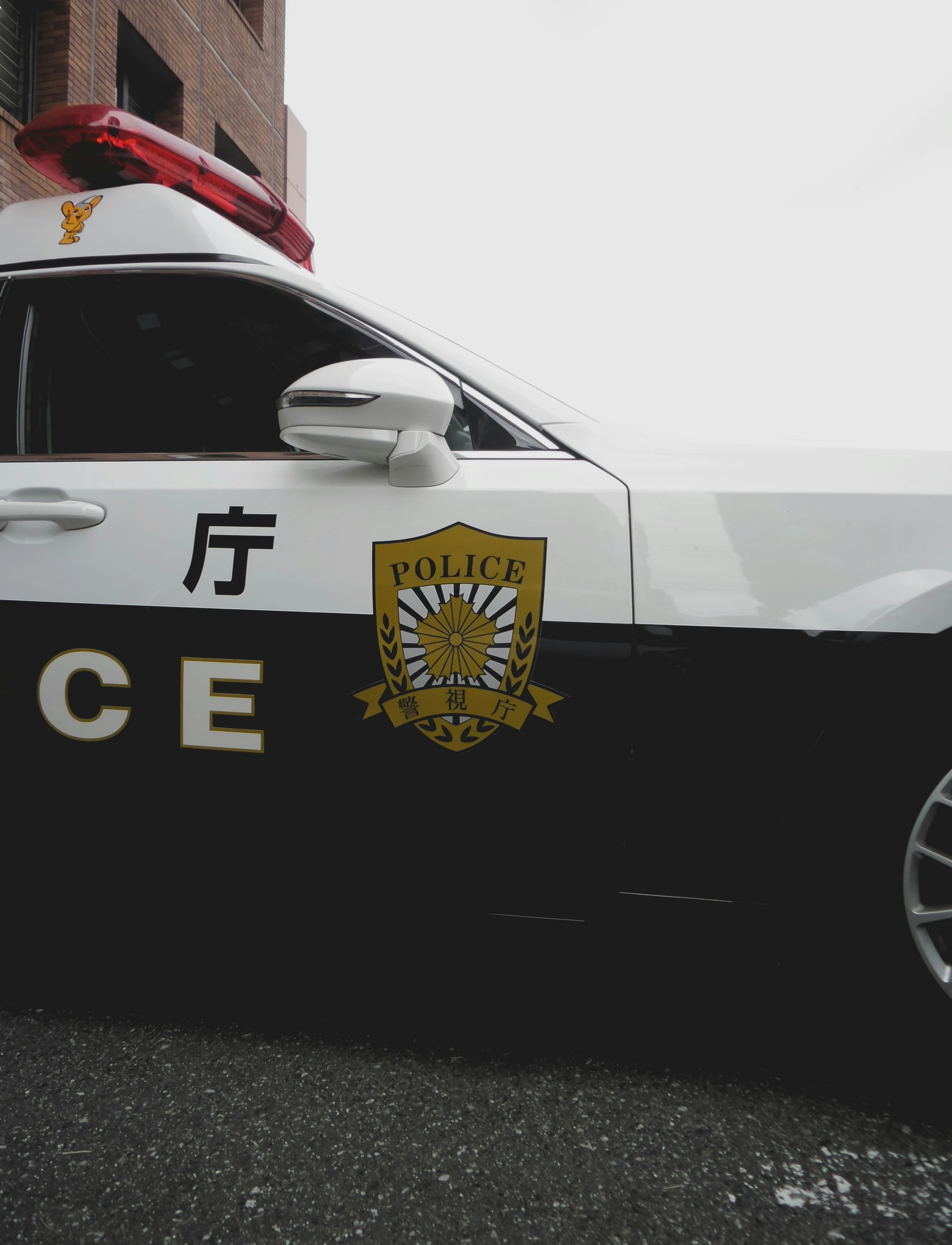 an officer car parked in front of a brick building