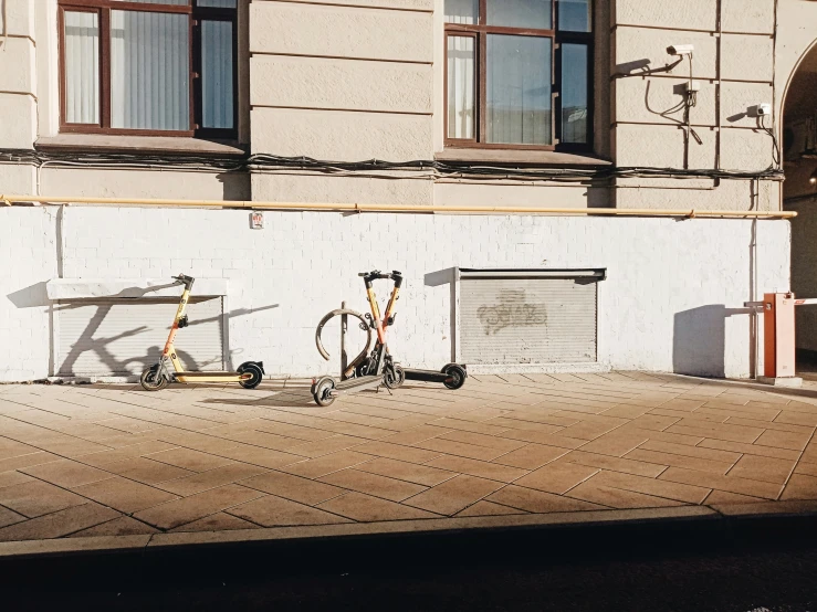 two bicycles parked next to each other on a city street