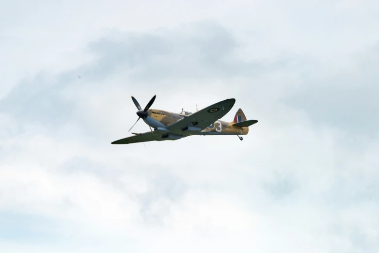 an old propeller airplane flying in the sky