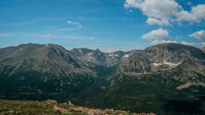 a couple of mountains with a forest on top