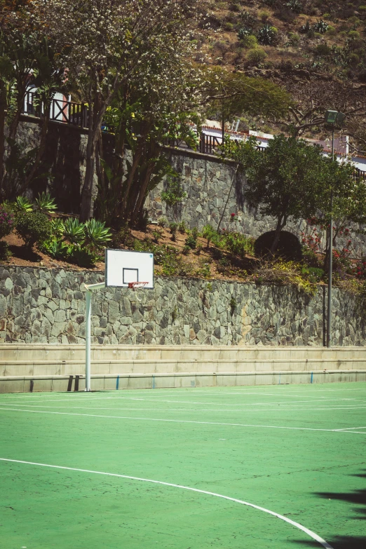 a basketball field with a ball laying on the floor