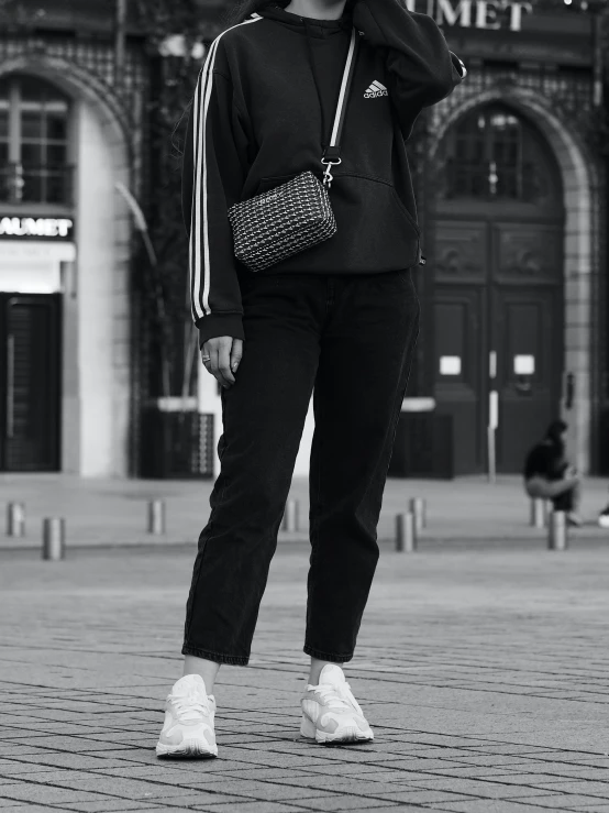 a woman stands on a street corner and poses for a po