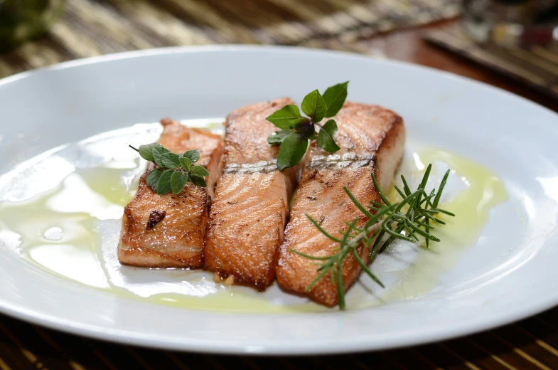 fish with herbs and herbs on a white plate