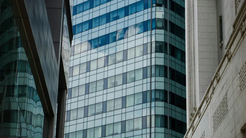 a very tall building next to another one in the city