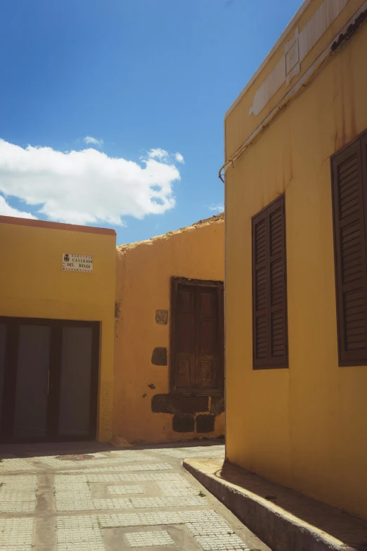 a yellow building with doors opened on it