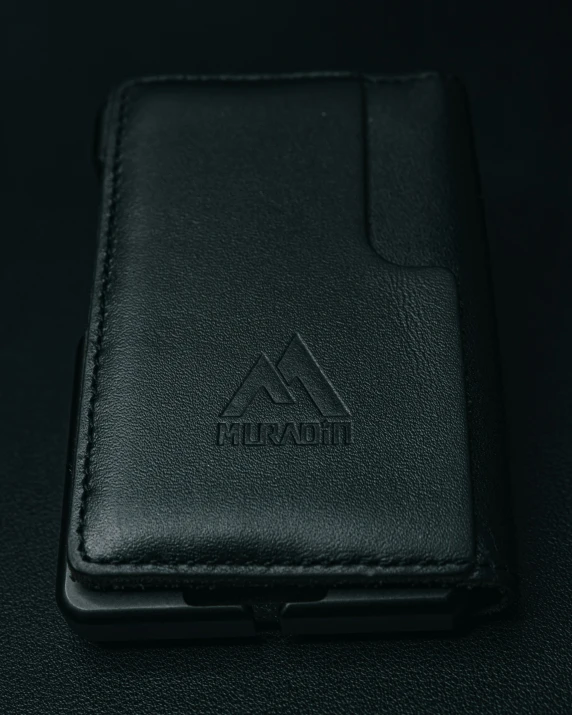 there is a black leather wallet with a logo on it