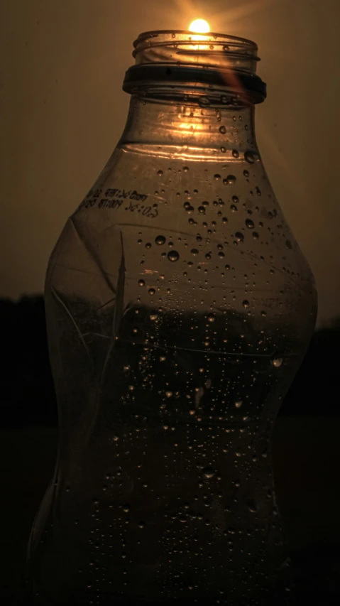 the light shines brightly behind a clear bottle