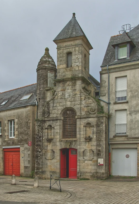 an old church sits in the middle of a cobblestone road