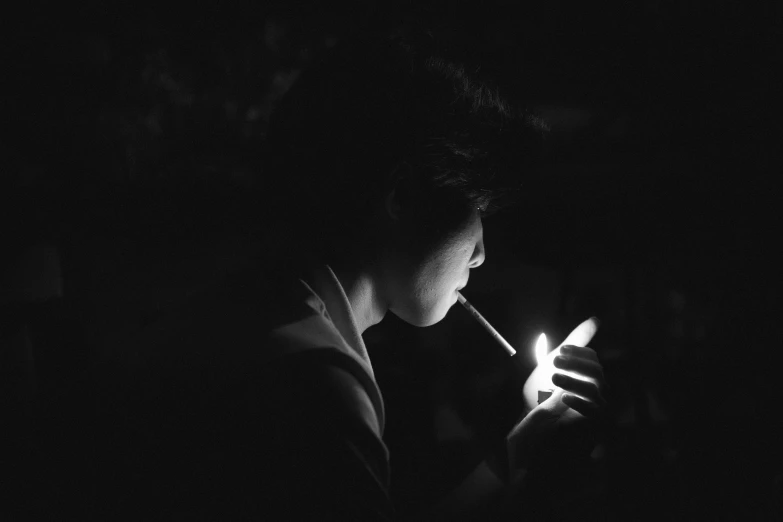 black and white po of a man smoking an electronic cigarette