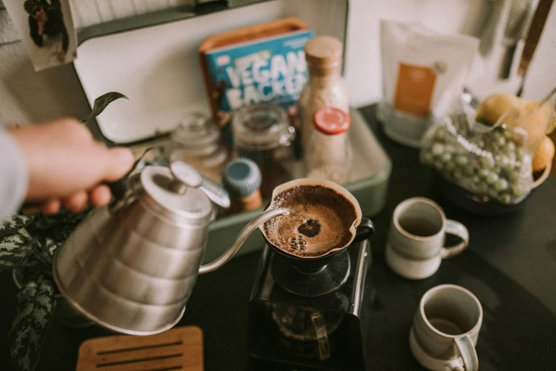 someone making a cup of tea at their kitchen counter