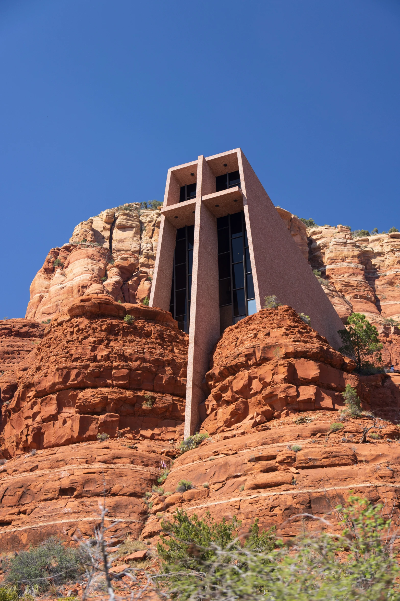 a window at the top of a mountain in red sand