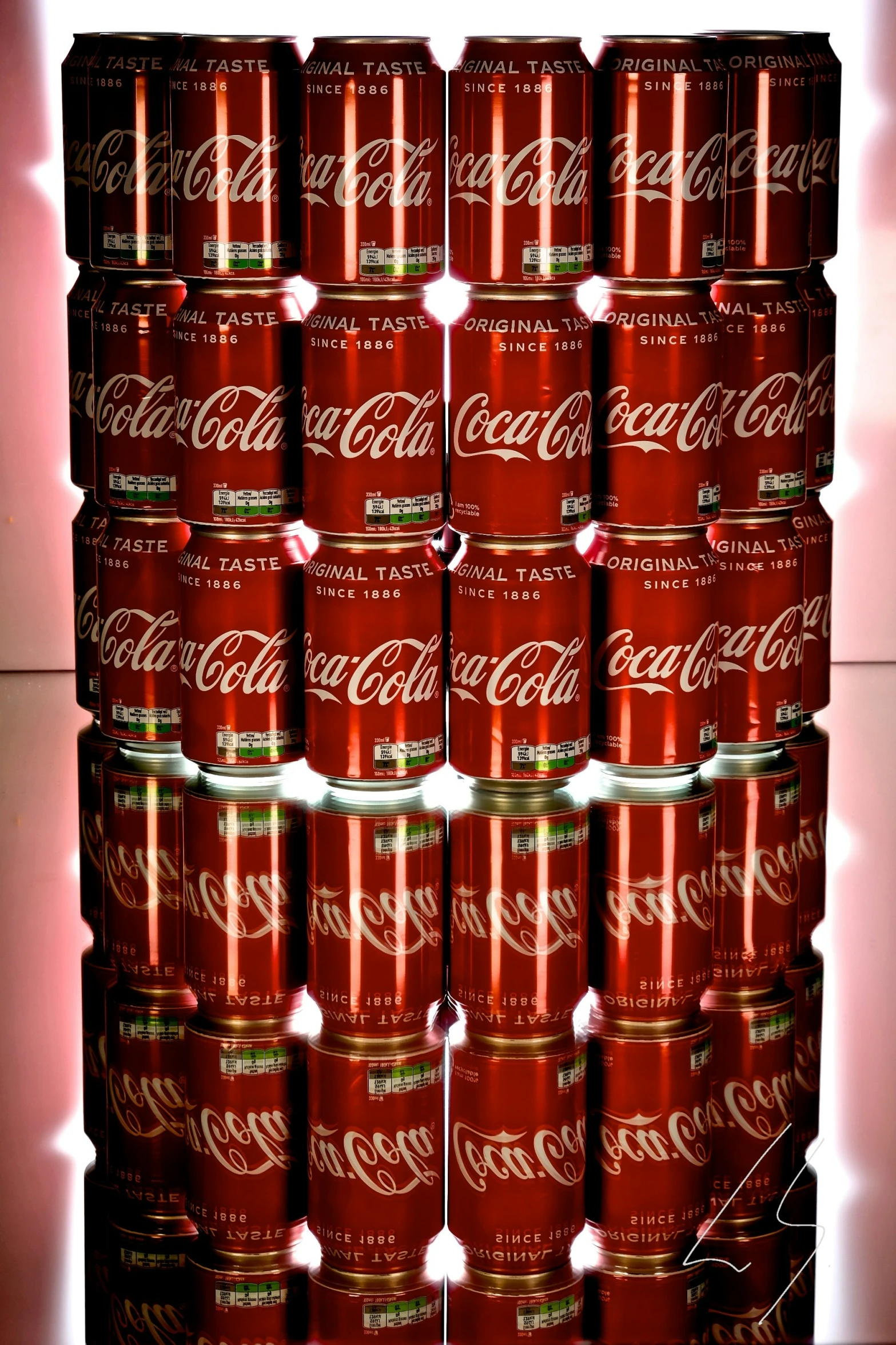 a large display of coca - cola cans is lit up with lights