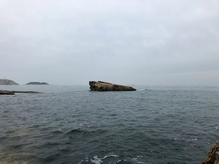 a large body of water near a rocky shore