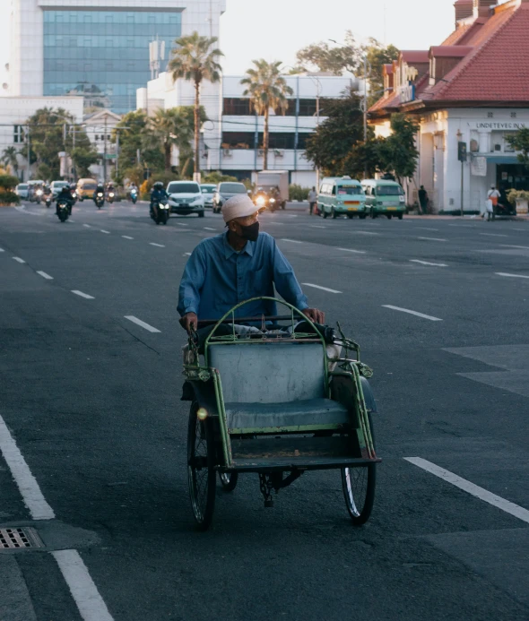 a man driving a small car down the street