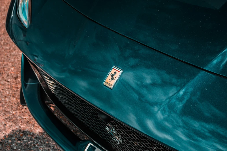 close up of a very green car on a dirt road